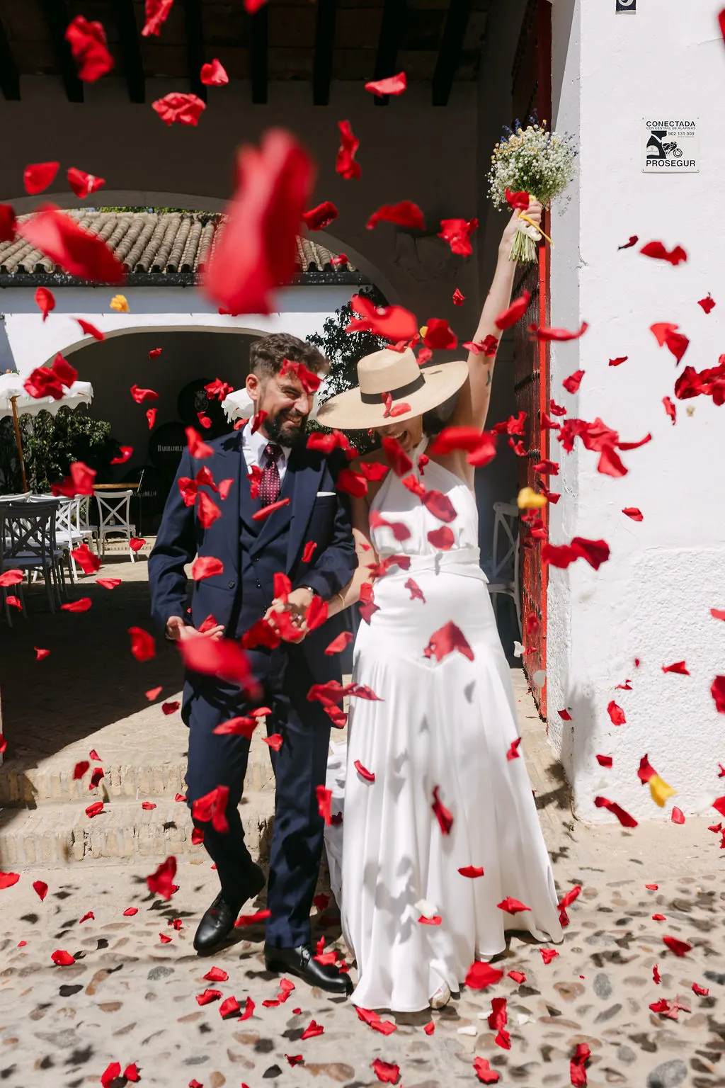 MªCarmen y Jose Miguel saliendo entre pétalos rojos en Bodegas Barbadillo